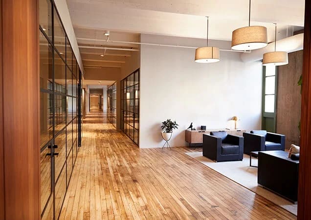 business-premises A modern commercial building with large glass windows and a sleek gray facade.