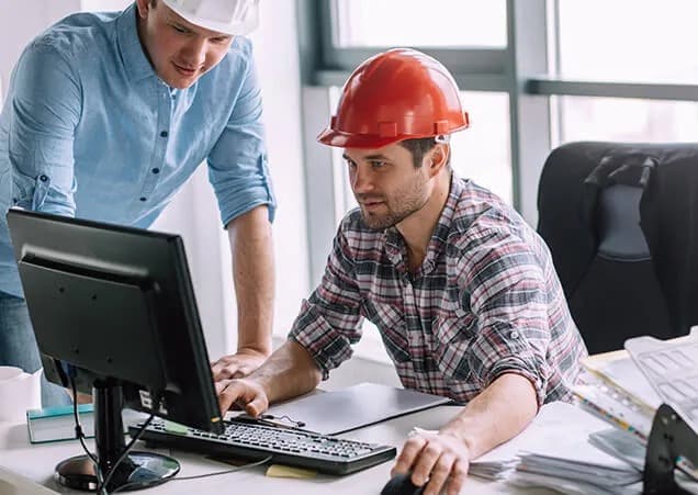 Claims management concept – A person reviewing insurance documents with a laptop and clipboard in view.
