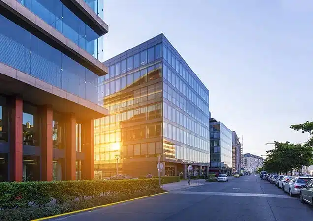 commercial-property-thumb A modern commercial property with large glass windows and a well-maintained exterior, set against a clear blue sky.