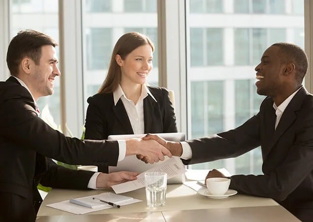 A group of diverse employees in a professional setting, engaged in discussion, symbolizing workplace safety and employee protection.