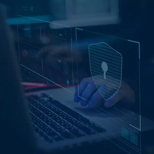 Cyber insurance banner showing digital security icons and a person using a laptop, representing protection against cyber threats.